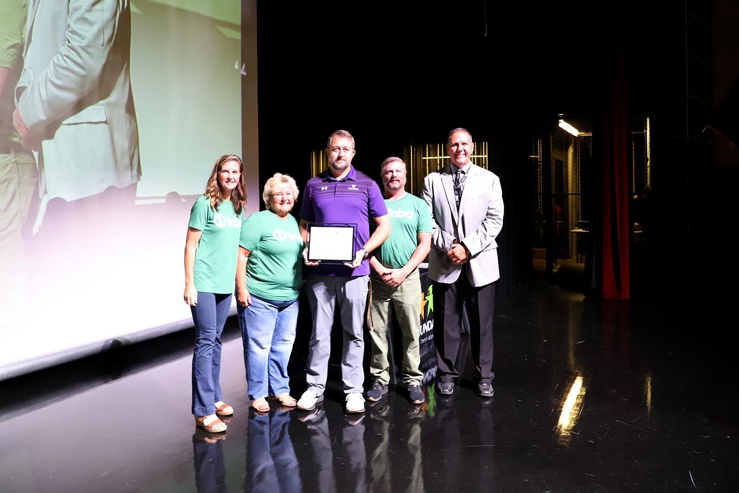 Tyler Madison accepting his Teacher of the Year Award on state at GIPS Welcome Back
